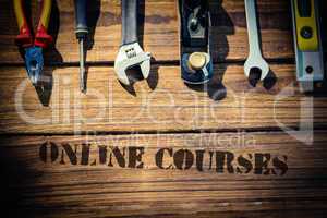 Online courses against desk with tools