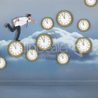 Composite image of geeky young businessman running late