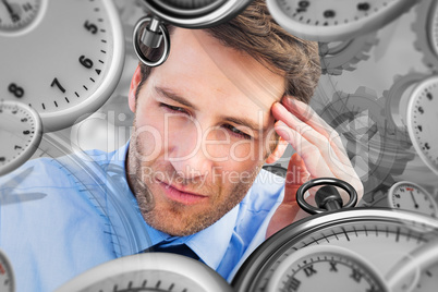 Composite image of stressed businessman holding his head