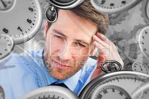 Composite image of stressed businessman holding his head