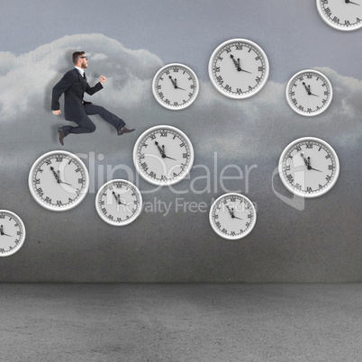 Composite image of geeky young businessman running mid air