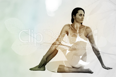 Composite image of fit woman doing the half spinal twist pose in