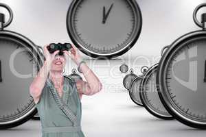 Composite image of a businesswoman looking through binoculars