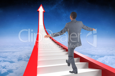 Composite image of businessman performing a balancing act