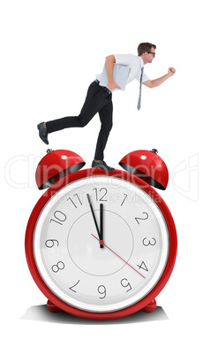 Composite image of geeky businessman running late