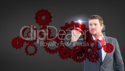 Composite image of focused businessman pointing with finger