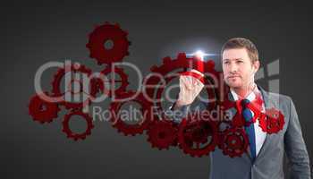 Composite image of focused businessman pointing with finger