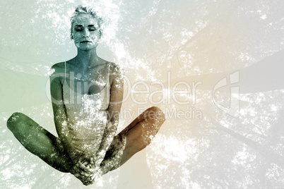 Composite image of toned woman doing the butterfly stretch