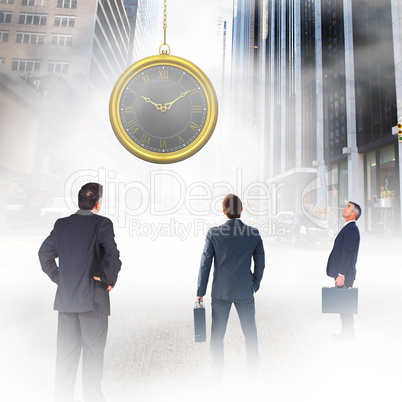 Composite image of businessman carrying briefcase