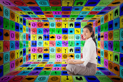 Composite image of businesswoman sitting in lotus pose