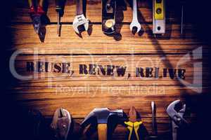 Reuse, renew, relive against desk with tools