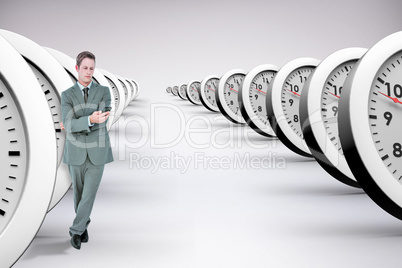 Composite image of handsome businessman texting on phone