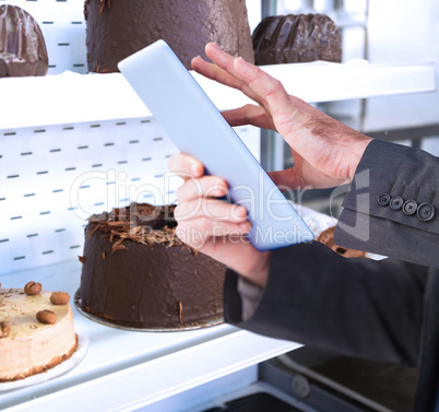 Composite image of businessman scrolling on his digital tablet