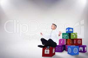 Composite image of peaceful businessman sitting in lotus pose