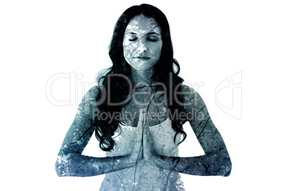 Composite image of pretty brunette doing yoga