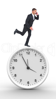 Composite image of businessman running on the phone