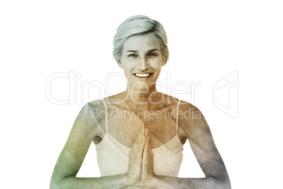 Composite image of happy woman doing yoga smiling at camera