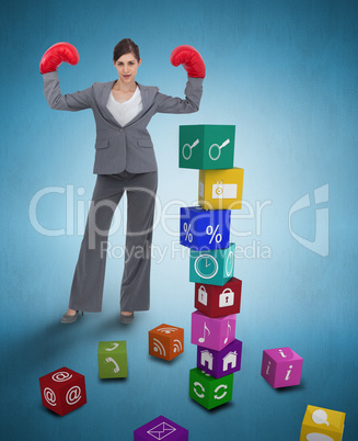 Composite image of businesswoman with boxing gloves