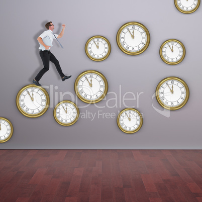 Composite image of geeky businessman running late