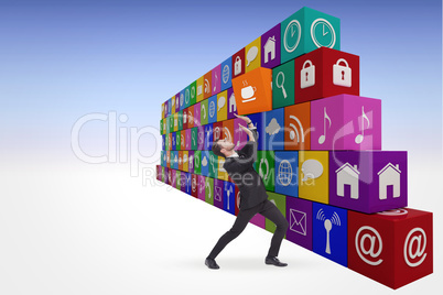 Composite image of focused businessman pushing with hands