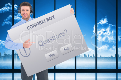 Composite image of businessman showing card wearing headset