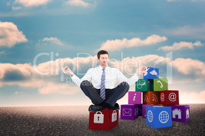 Composite image of businessman meditating in lotus pose