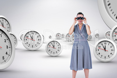 Composite image of a businesswoman looking through binoculars