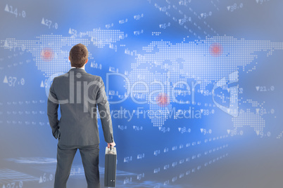 Composite image of businessman standing with his briefcase