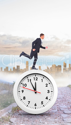 Composite image of businessman running