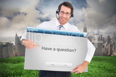 Composite image of happy businessman showing card to camera