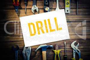 Drill against desk with tools