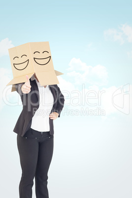 Composite image of businesswoman showing thumbs up with box over