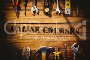 Online courses against desk with tools