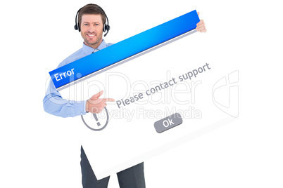 Composite image of businessman showing card wearing headset