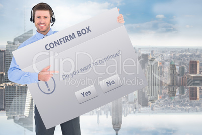 Composite image of businessman showing card wearing headset