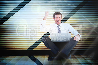 Composite image of businessman using laptop and cheering