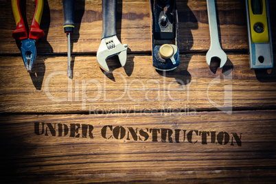 Under construction against desk with tools