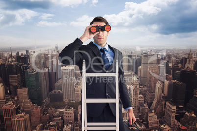 Composite image of businessman looking on a ladder