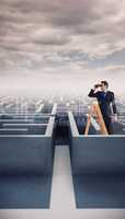 Composite image of businessman looking on a ladder