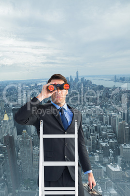 Composite image of businessman looking on a ladder