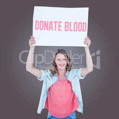 Composite image of woman holding poster Composite image of woman holding poster