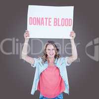 Composite image of woman holding poster