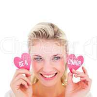 Composite image of attractive young blonde holding little hearts