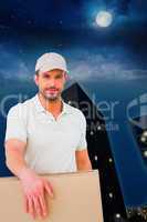 Composite image of delivery man carrying package