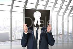 Composite image of businessman holding board