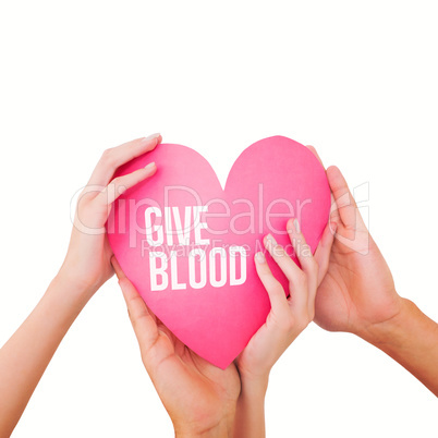 Composite image of couple holding a paper heart