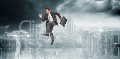 Composite image of happy businessman in a hurry