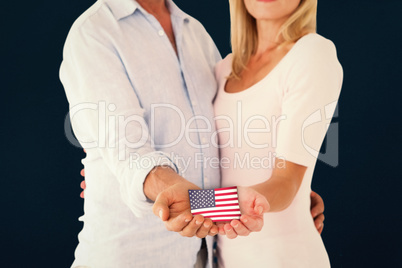 Composite image of happy couple holding their hands out