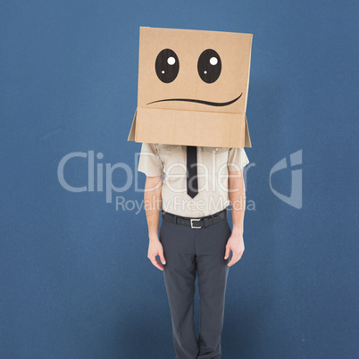 Composite image of businessman standing with box on head