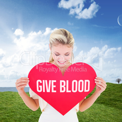 Composite image of attractive young blonde showing red heart